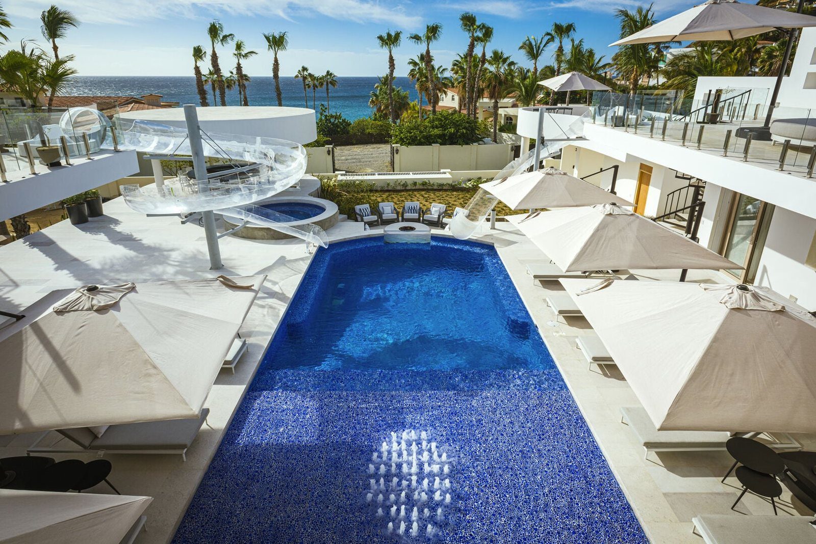 Casa Aqua Blanca pool with waterslides and ocean in the background