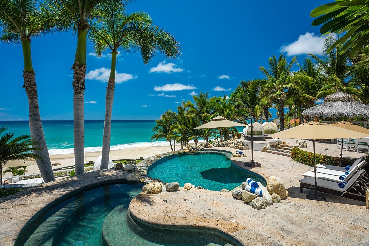 Casa Edwards pool and palms above the beach and ocean in Palmilla